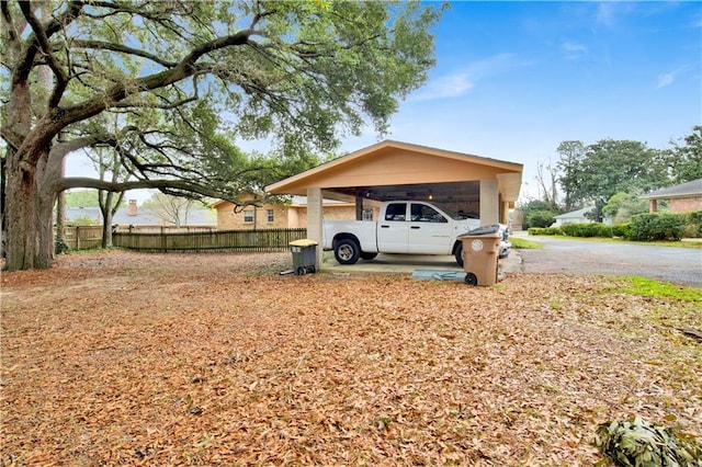 view of yard with a carport and fence