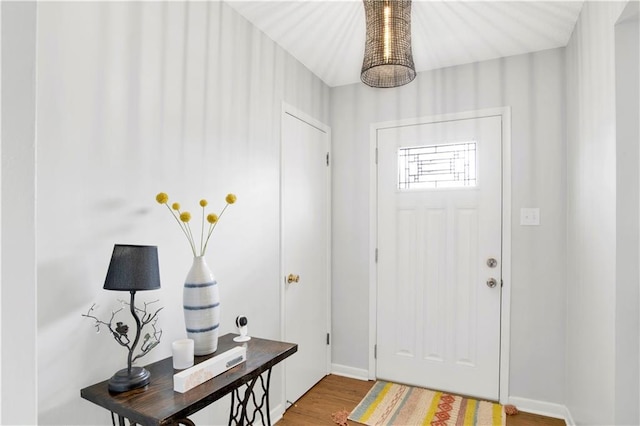 entryway featuring baseboards and wood finished floors