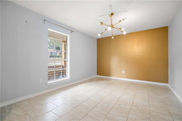 spare room featuring a notable chandelier and light tile patterned floors