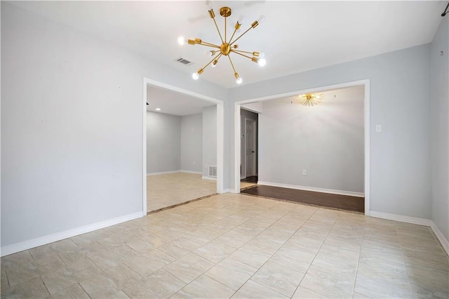 empty room featuring an inviting chandelier