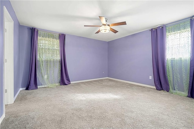 empty room featuring ceiling fan and carpet floors