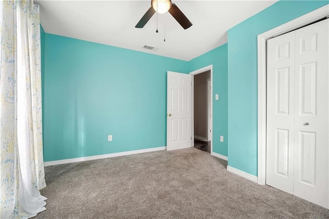 unfurnished bedroom with carpet, ceiling fan, and a closet