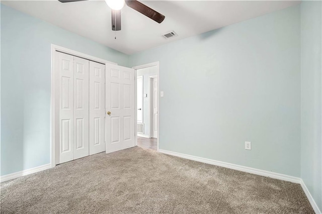 unfurnished bedroom featuring carpet, a closet, and ceiling fan