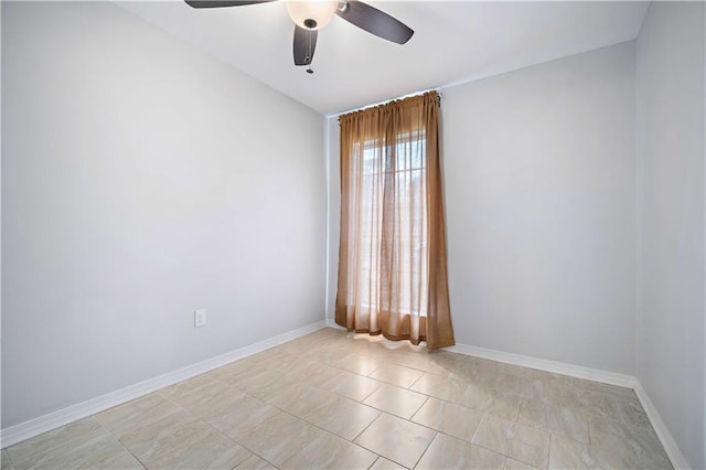 spare room featuring ceiling fan and light tile patterned floors