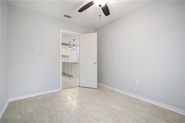 unfurnished room with ceiling fan