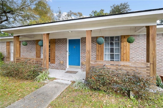 view of exterior entry with a porch