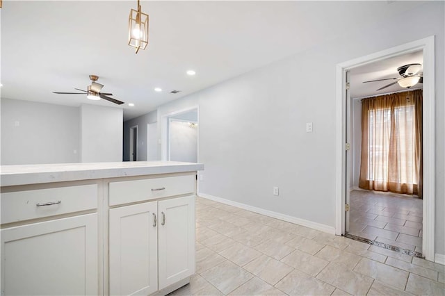 kitchen featuring white cabinetry, light tile patterned flooring, hanging light fixtures, and ceiling fan