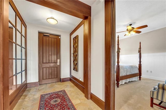 18269 Colony Dr Unit 405, Fairhope, AL 36532 - entryway with baseboards, stone tile flooring, ceiling fan, and a wainscoted wall