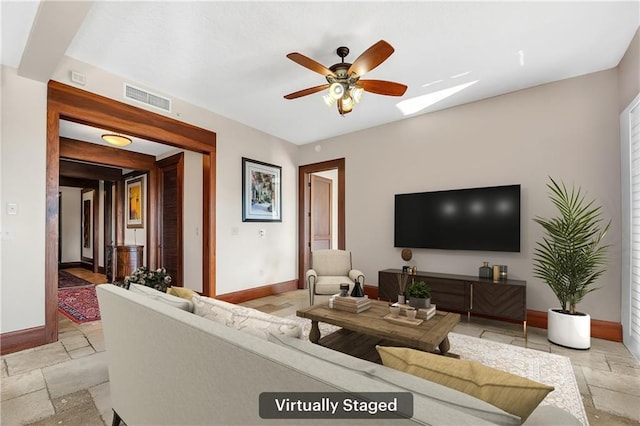 18269 Colony Dr Unit 405, Fairhope, AL 36532 - living area featuring baseboards, stone tile floors, ceiling fan, and a skylight