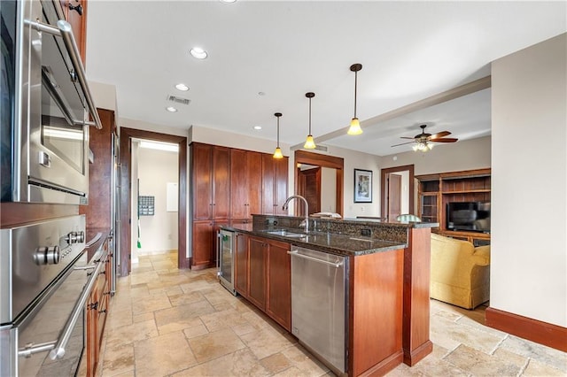 18269 Colony Dr Unit 405, Fairhope, AL 36532 - kitchen with stainless steel appliances, a sink, beverage cooler, stone tile floors, and dark stone countertops
