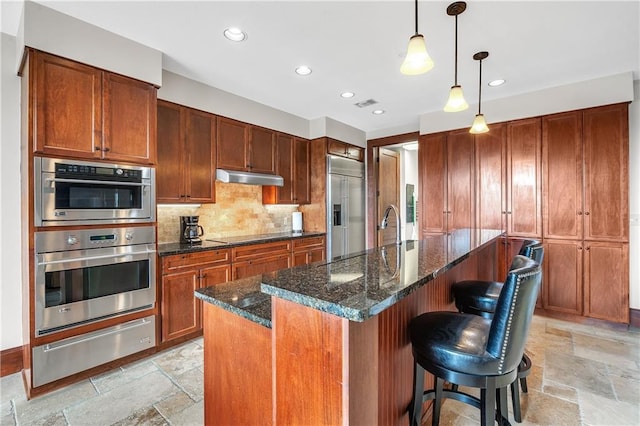18269 Colony Dr Unit 405, Fairhope, AL 36532 - kitchen with a warming drawer, appliances with stainless steel finishes, stone tile flooring, under cabinet range hood, and recessed lighting