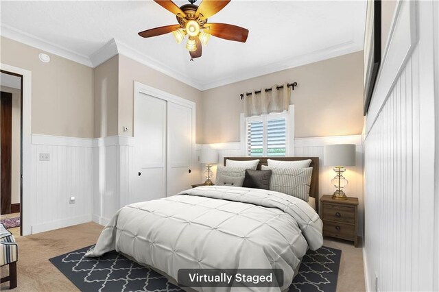 18269 Colony Dr Unit 405, Fairhope, AL 36532 - bedroom featuring light carpet, a closet, wainscoting, ornamental molding, and a ceiling fan
