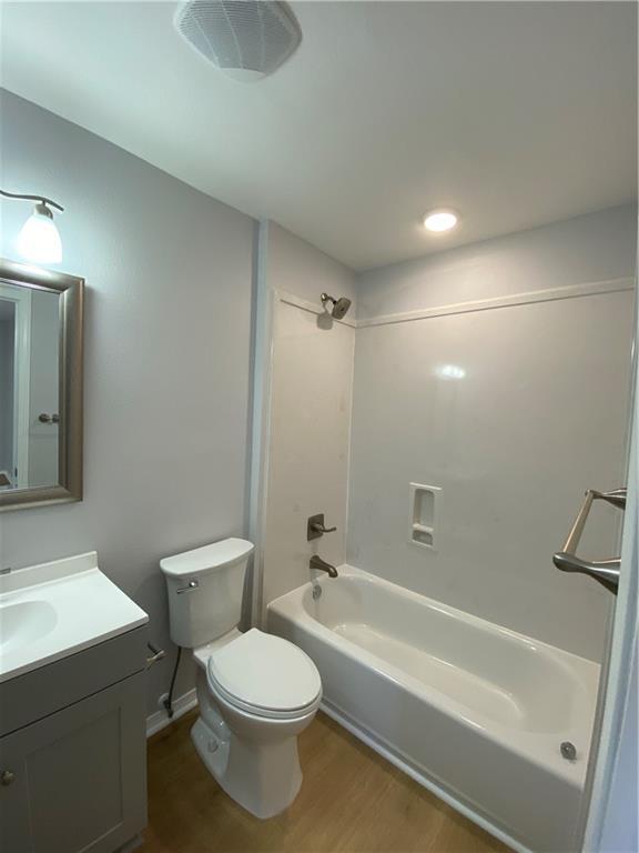 112 Du Rhu Dr Unit 112-H, Mobile, AL 36608 - full bathroom with wood finished floors, vanity, toilet, and shower / bathtub combination