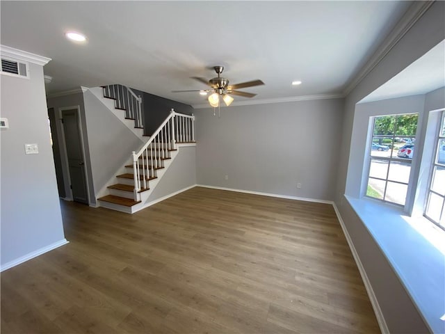 112 Du Rhu Dr Unit 112-H, Mobile, AL 36608 - unfurnished living room featuring ornamental molding, baseboards, stairs, a ceiling fan, and wood finished floors