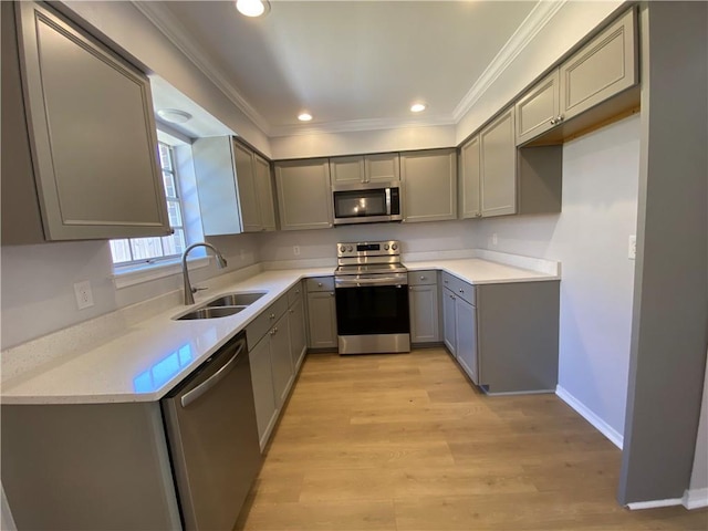 112 Du Rhu Dr Unit 112-H, Mobile, AL 36608 - kitchen featuring stainless steel appliances, a sink, gray cabinetry, crown molding, and light wood finished floors