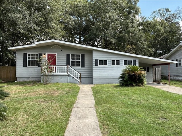 view of front facade featuring fence, concrete driveway, crawl space, an attached carport, and a front yard