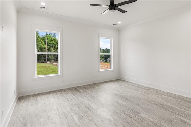 empty room featuring light wood-type flooring, plenty of natural light, and ceiling fan