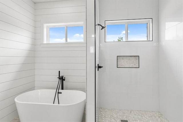 bathroom with independent shower and bath and plenty of natural light