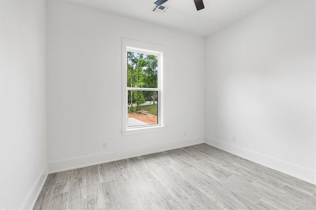 spare room with light hardwood / wood-style floors and ceiling fan