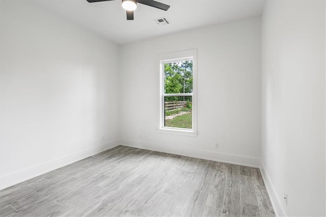 unfurnished room featuring light wood-type flooring, a wealth of natural light, and ceiling fan