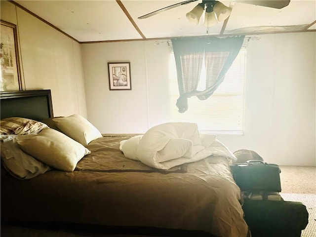 bedroom featuring ceiling fan, carpet, and ornamental molding