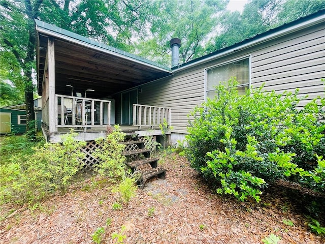 rear view of house with a wooden deck