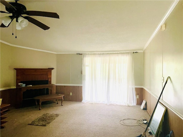 misc room featuring ceiling fan, crown molding, and carpet flooring