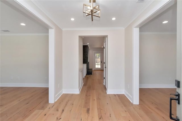 corridor featuring ornamental molding, recessed lighting, light wood-style flooring, and baseboards