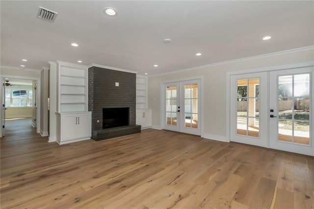 unfurnished living room with visible vents, ornamental molding, french doors, light wood-style floors, and recessed lighting