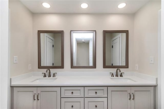 full bath with recessed lighting, a sink, and double vanity