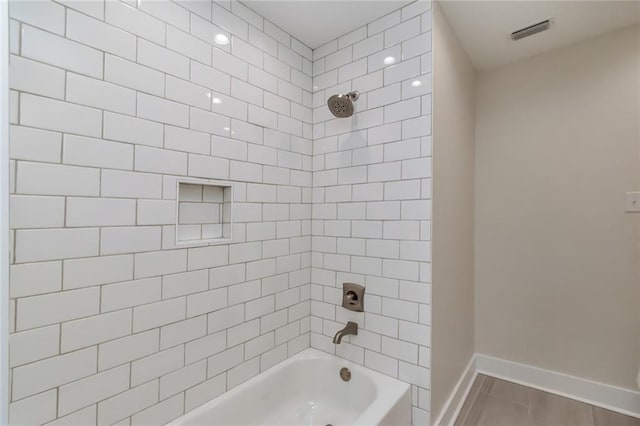 full bath featuring bathtub / shower combination, visible vents, and baseboards