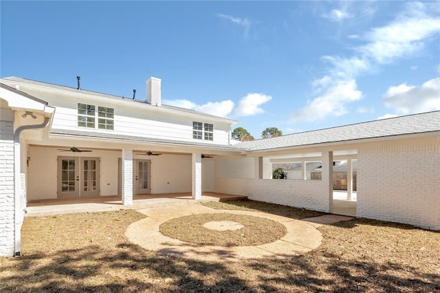 rear view of property with brick siding, a patio, a ceiling fan, and french doors