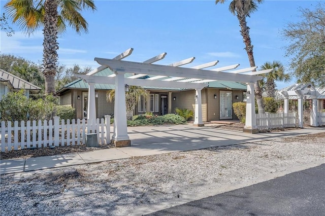 view of front of home with fence and a pergola