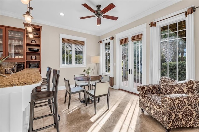 dining room featuring baseboards, ornamental molding, a ceiling fan, and recessed lighting