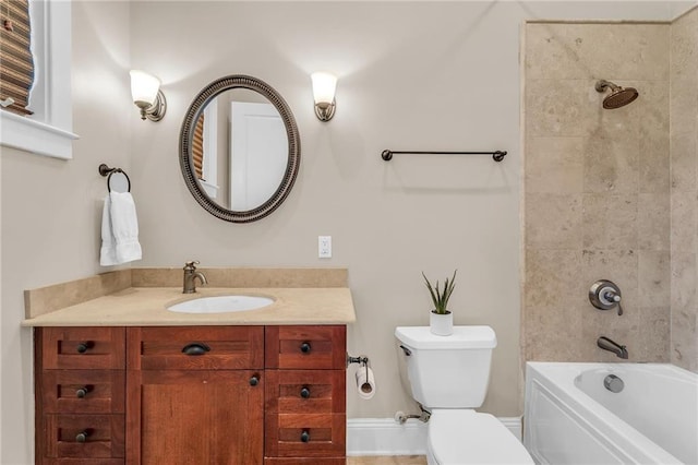 bathroom featuring toilet, shower / bathing tub combination, and vanity