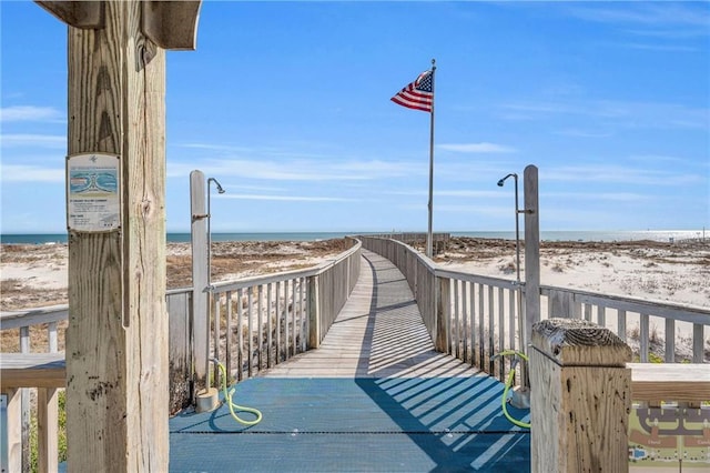 view of property's community featuring a beach view and a water view