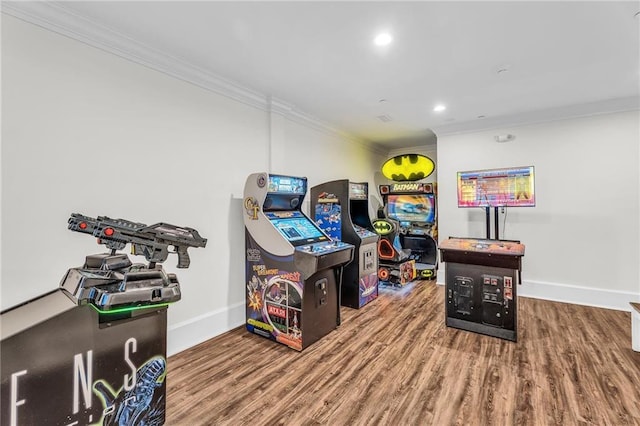 recreation room featuring recessed lighting, crown molding, baseboards, and wood finished floors