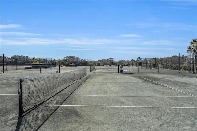 view of tennis court with fence