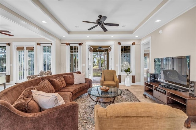 living room with french doors, a tray ceiling, a ceiling fan, and recessed lighting