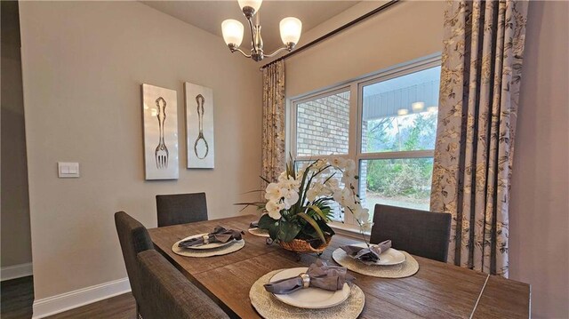 dining room with baseboards, dark wood-type flooring, and a chandelier
