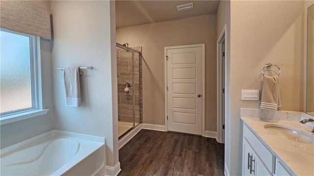 bathroom featuring visible vents, a healthy amount of sunlight, and a shower stall