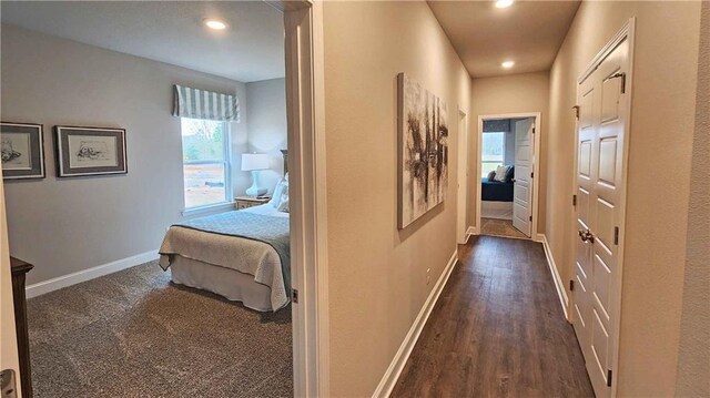 hallway with recessed lighting, baseboards, and dark wood-style floors