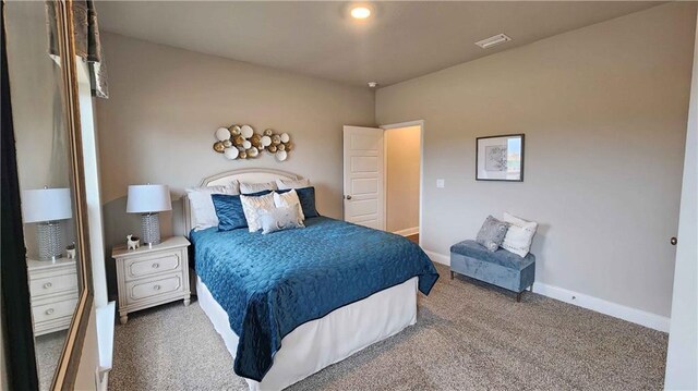 carpeted bedroom featuring baseboards and visible vents