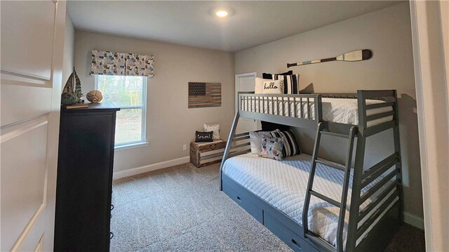 carpeted bedroom featuring baseboards