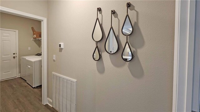 laundry area with washer / clothes dryer, laundry area, visible vents, and dark wood-style floors
