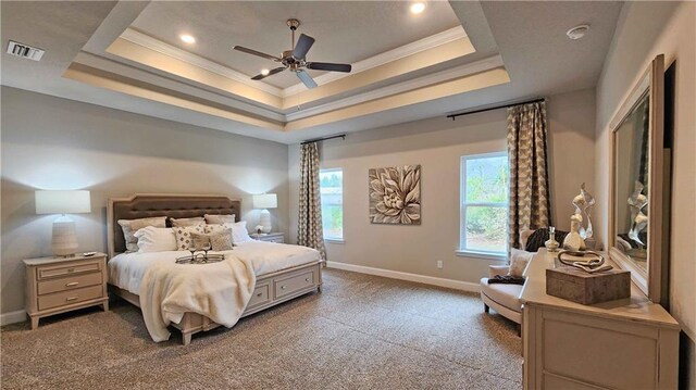 bedroom featuring visible vents, ornamental molding, a raised ceiling, and carpet floors
