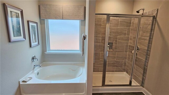 full bath with a garden tub and a stall shower