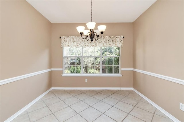 unfurnished dining area featuring tile patterned floors and a notable chandelier