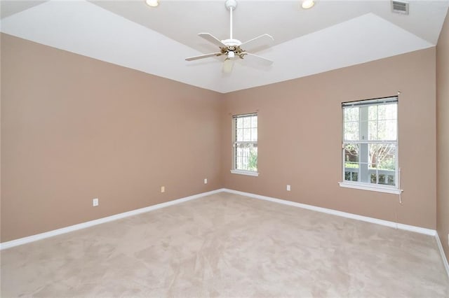 carpeted spare room with ceiling fan and lofted ceiling