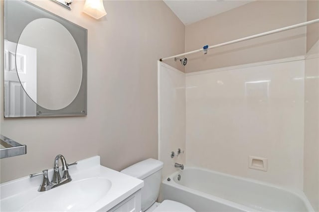 full bathroom featuring washtub / shower combination, vanity, and toilet